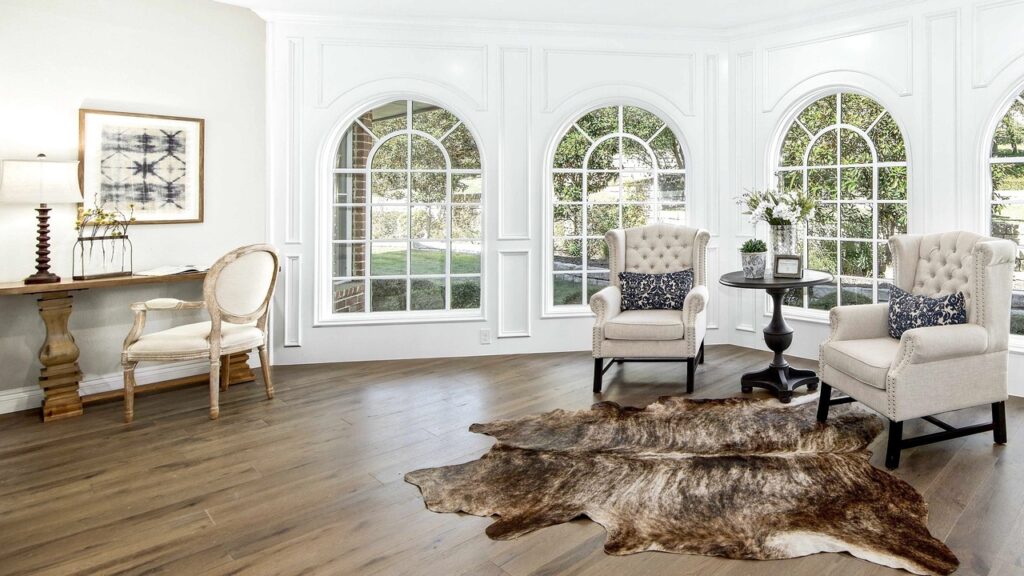 a beautiful living room with chairs and a mat